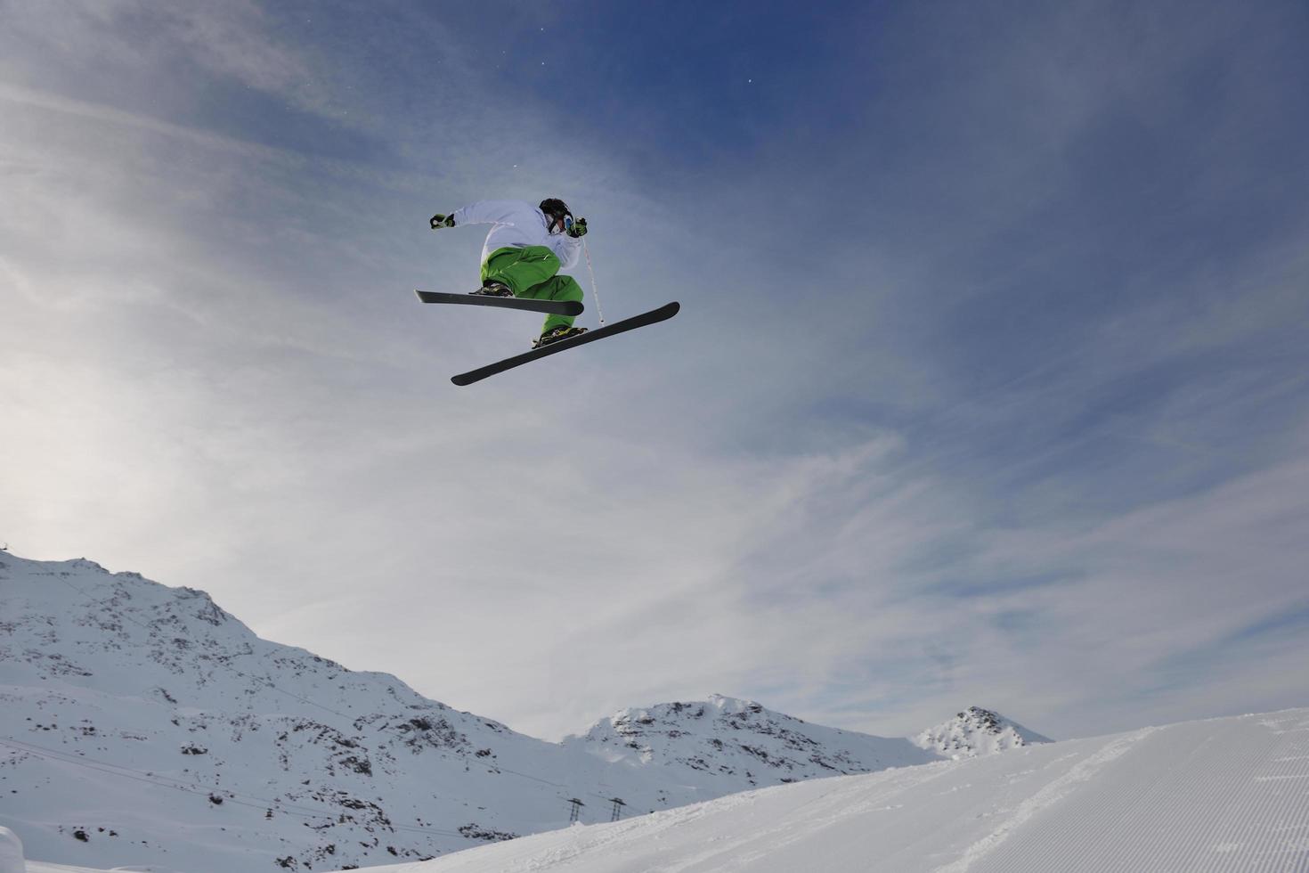 happy young man have fun at winter on mountain peak photo