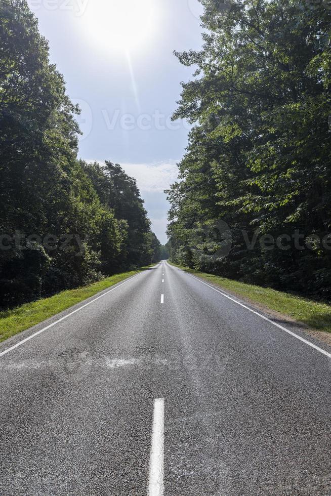 Narrow paved road for cars photo