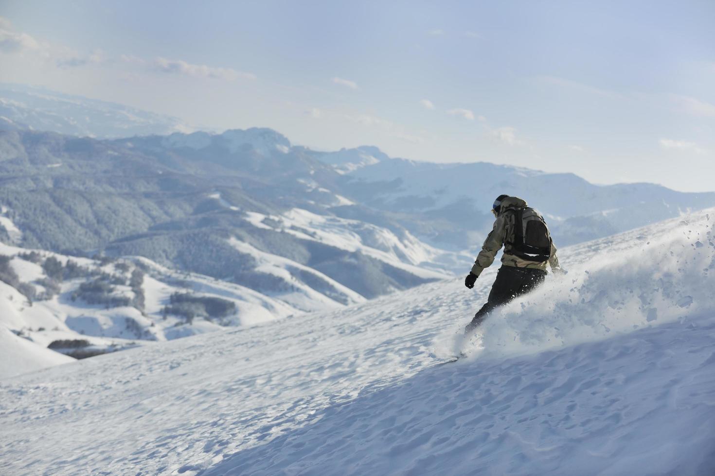 freestyle snowboarder jump and ride photo