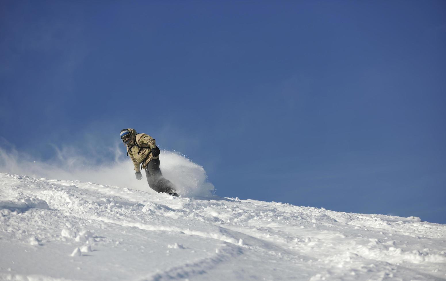 freestyle snowboarder jump and ride photo