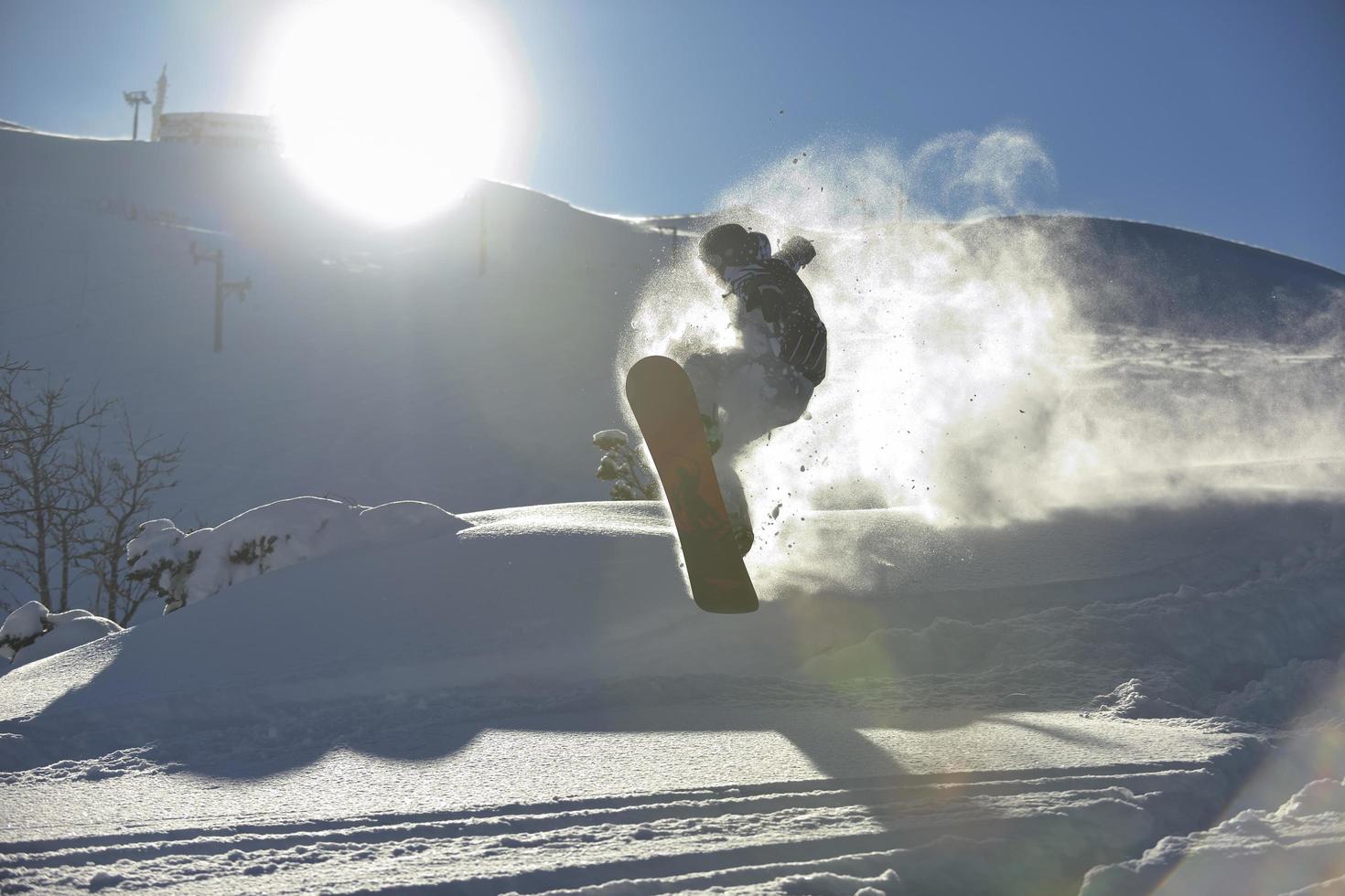 freestyle snowboarder jump and ride photo