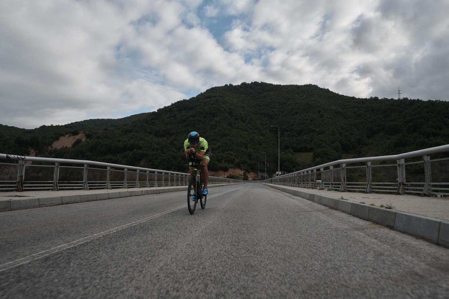 triathlon athlete riding a bike on morning training photo