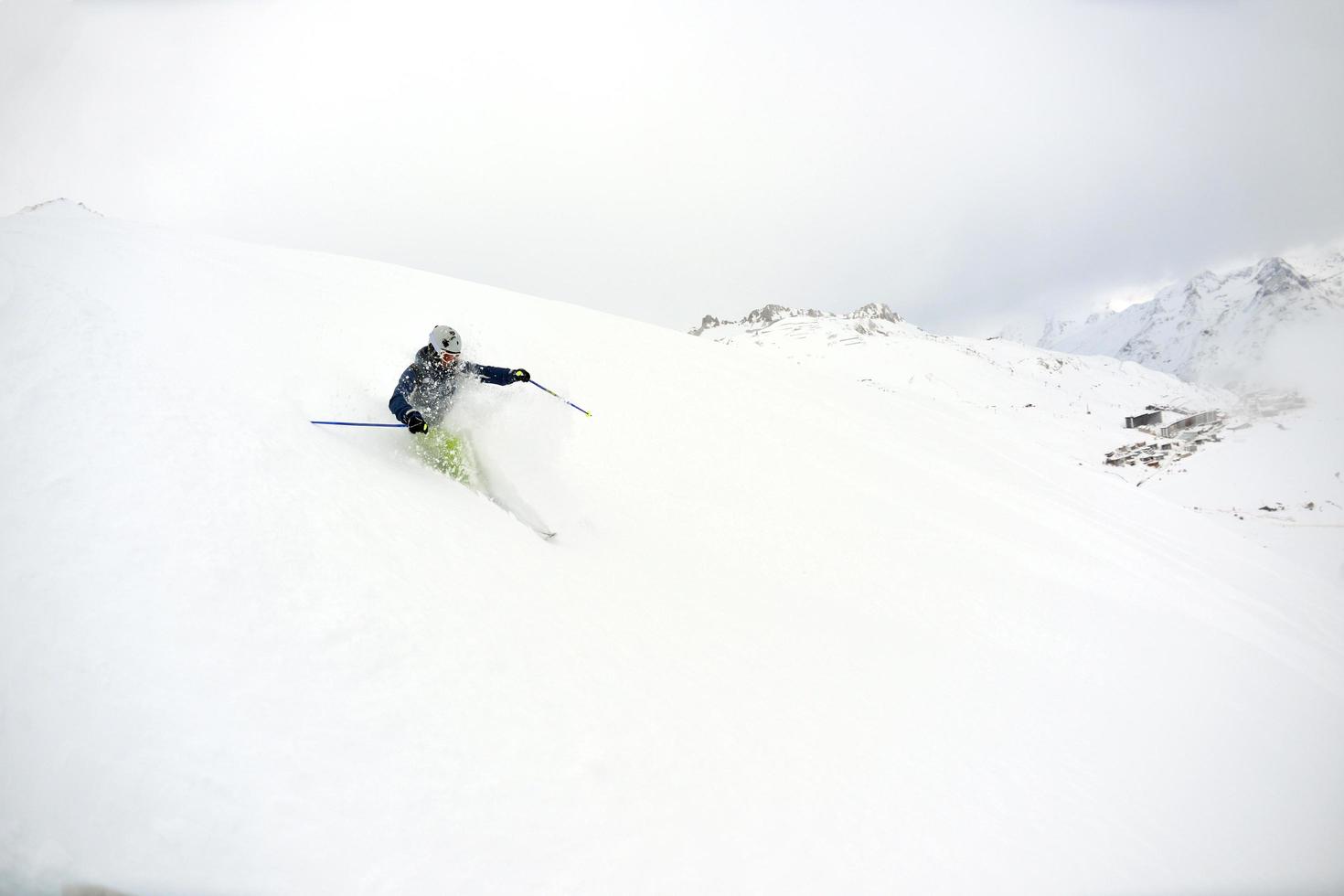 skiing on fresh snow at winter season at beautiful sunny day photo