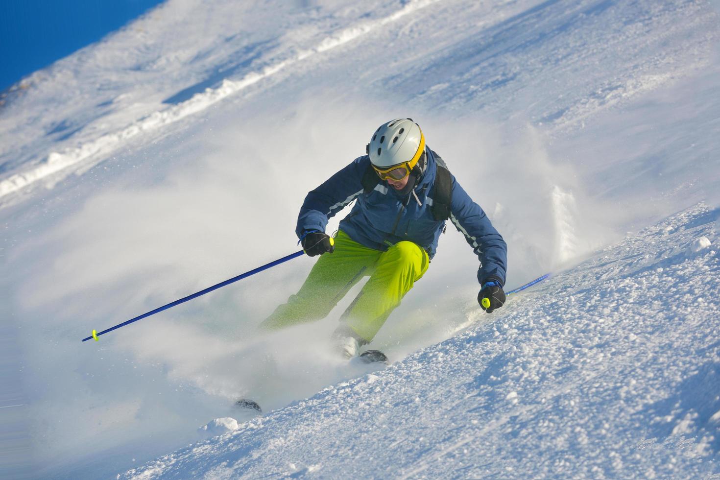 skiing on fresh snow at winter season at beautiful sunny day photo