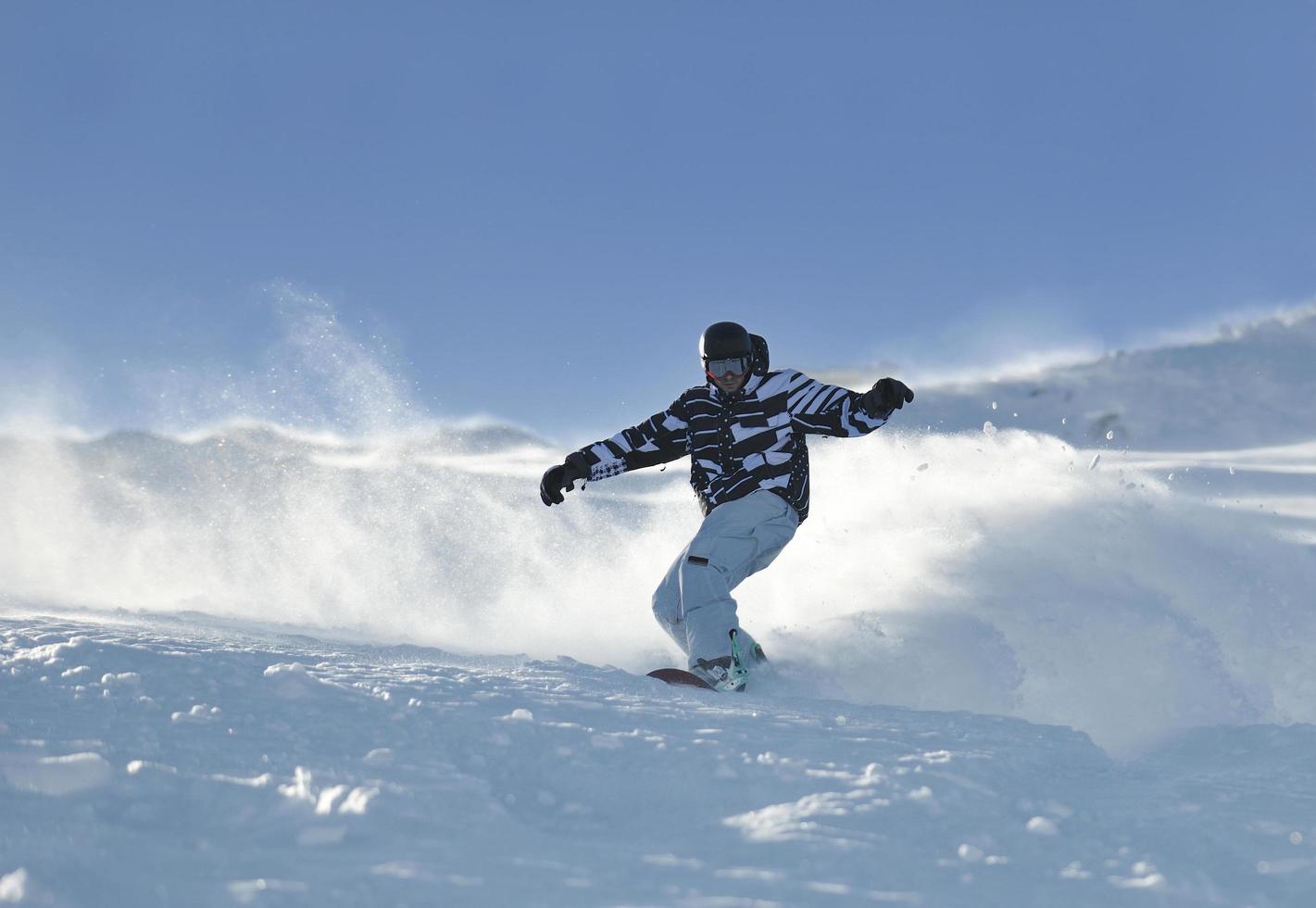 freestyle snowboarder jump and ride photo