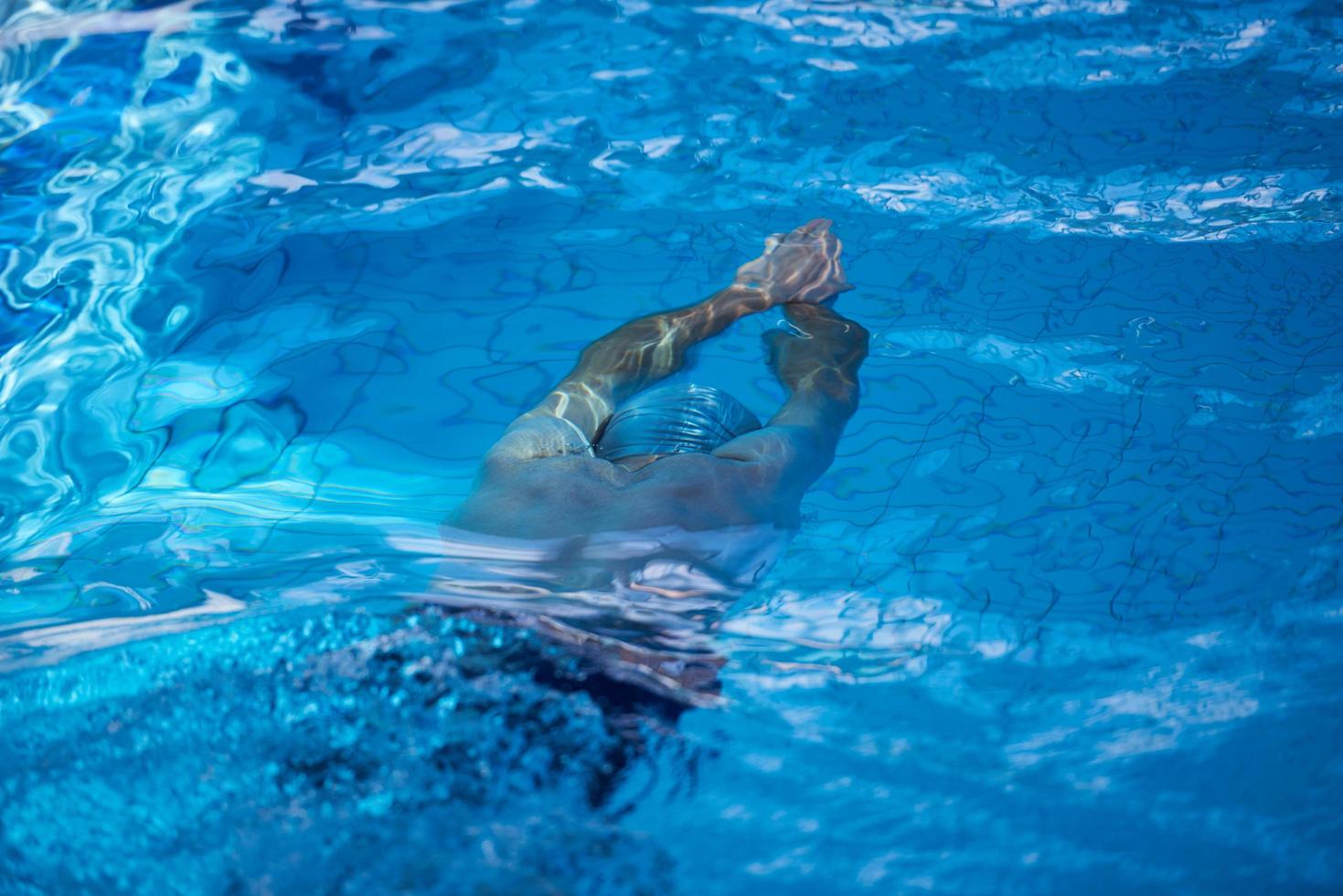 swimmer excercise on indoor swimming poo photo