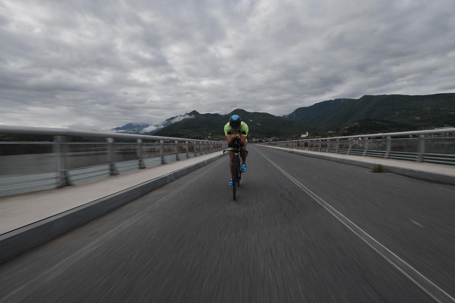 triathlon athlete riding a bike on morning training photo