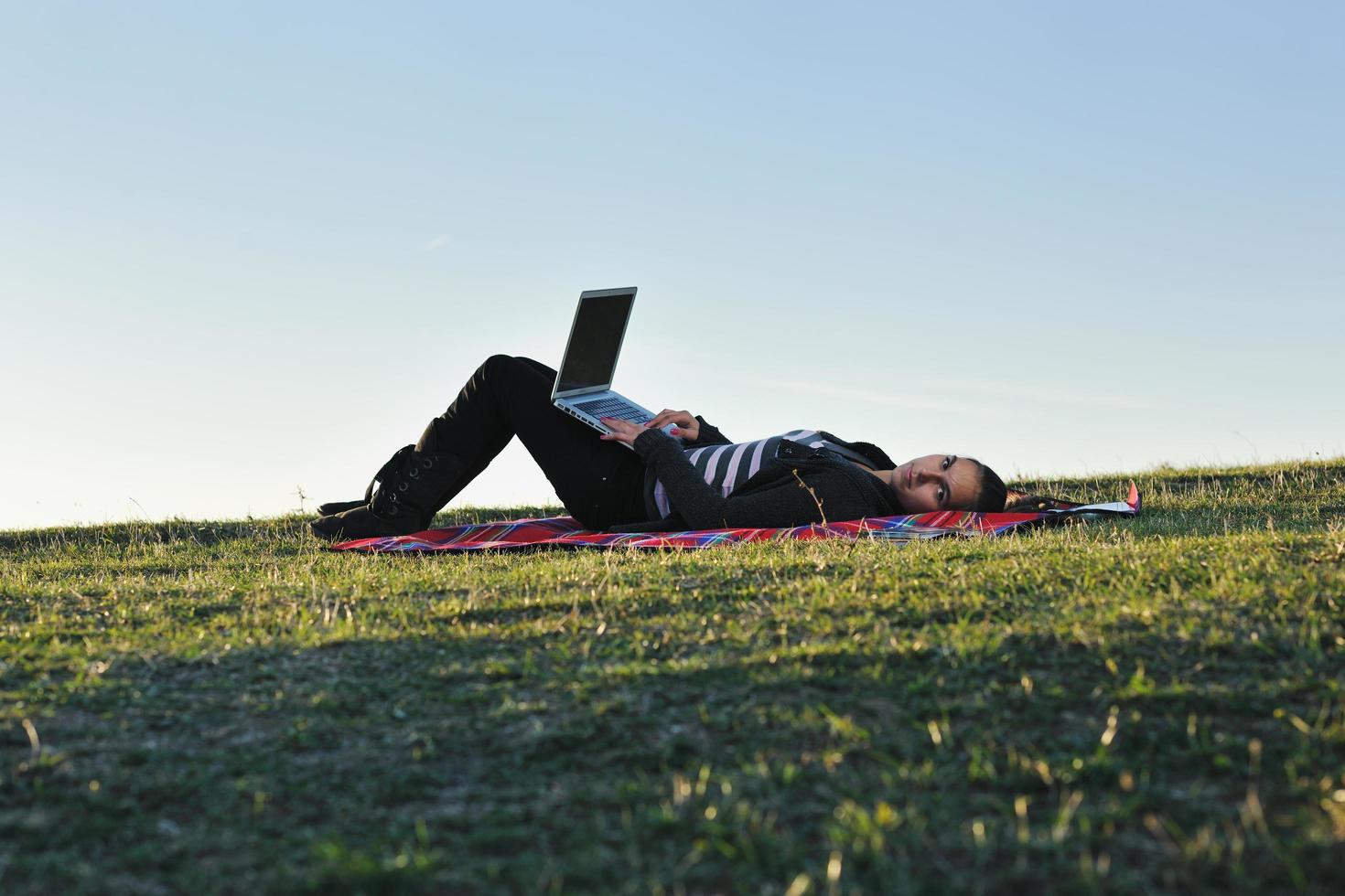 young teen girl work on laptop outdoor photo