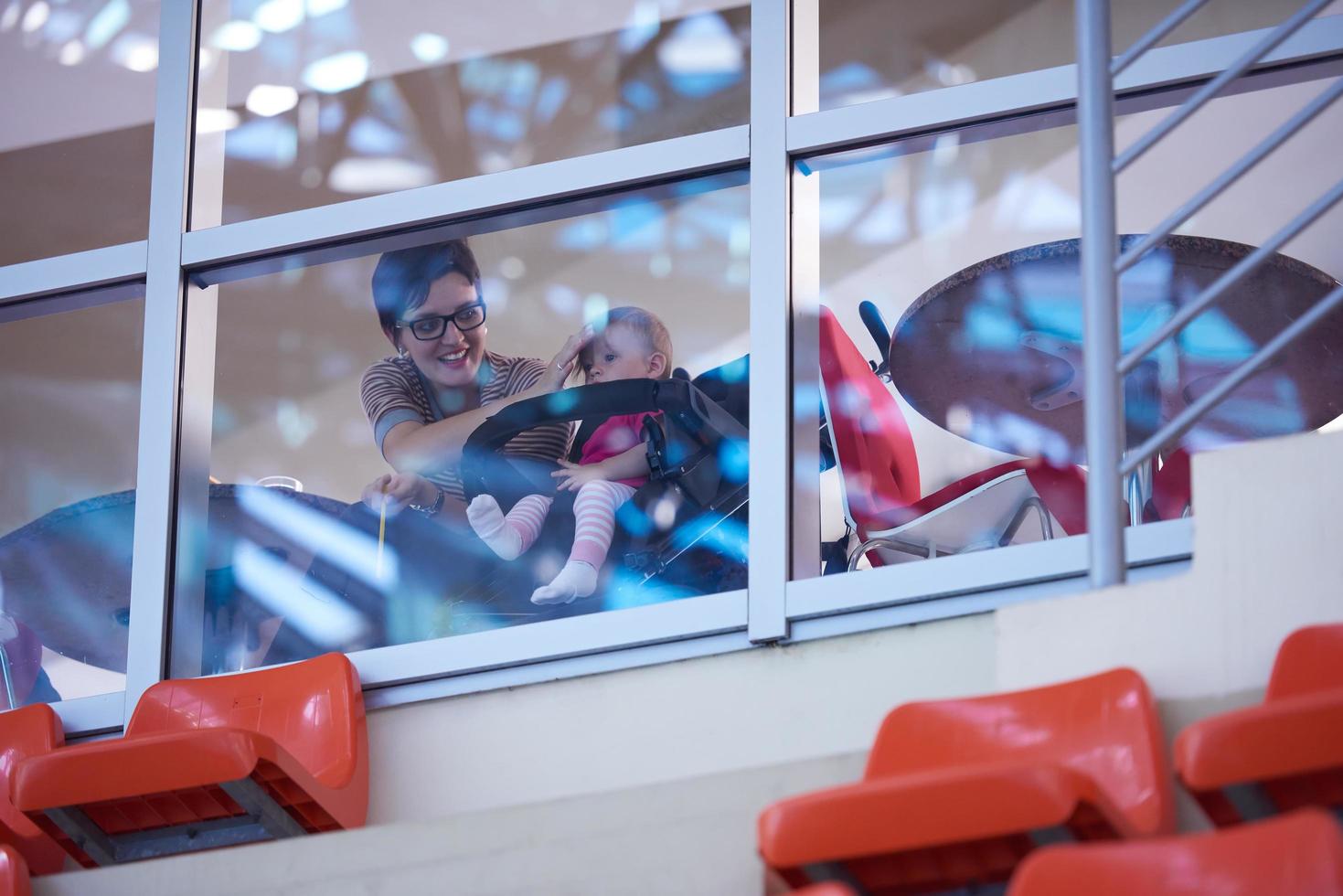 baby and mom looking trough window photo