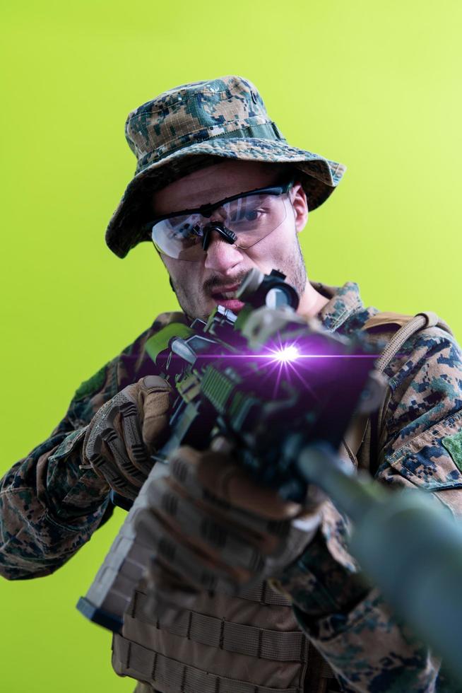 soldier in action aiming laseer sight optics green background photo