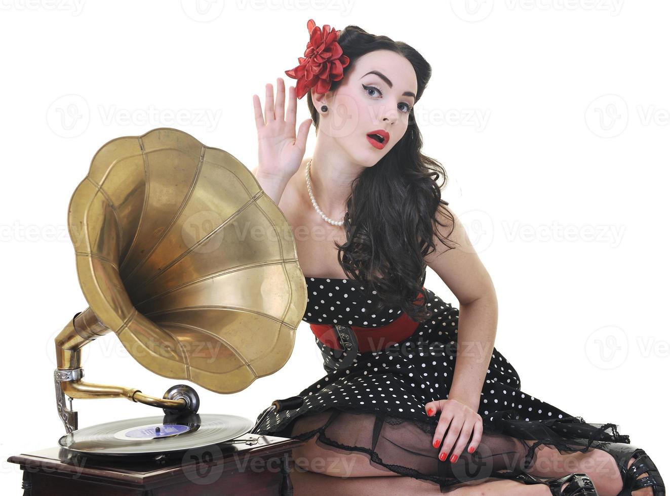 pretty girl listening music on old gramophone photo