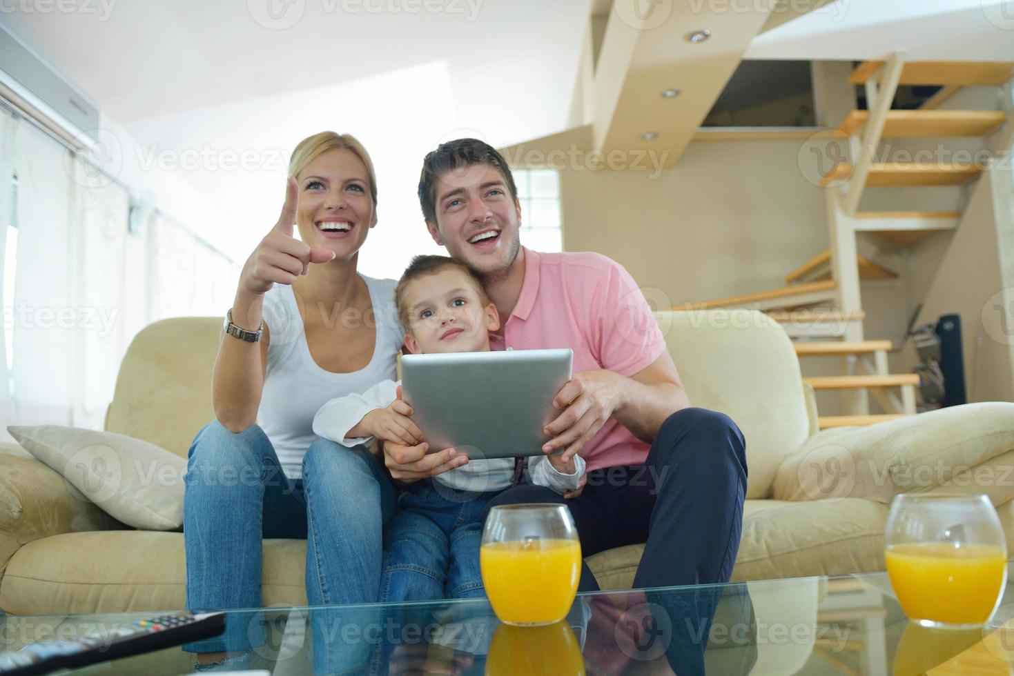 family at home using tablet computer photo