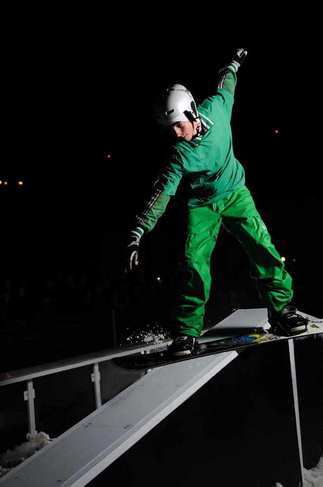 freestyle snowboarder jump in air at night photo