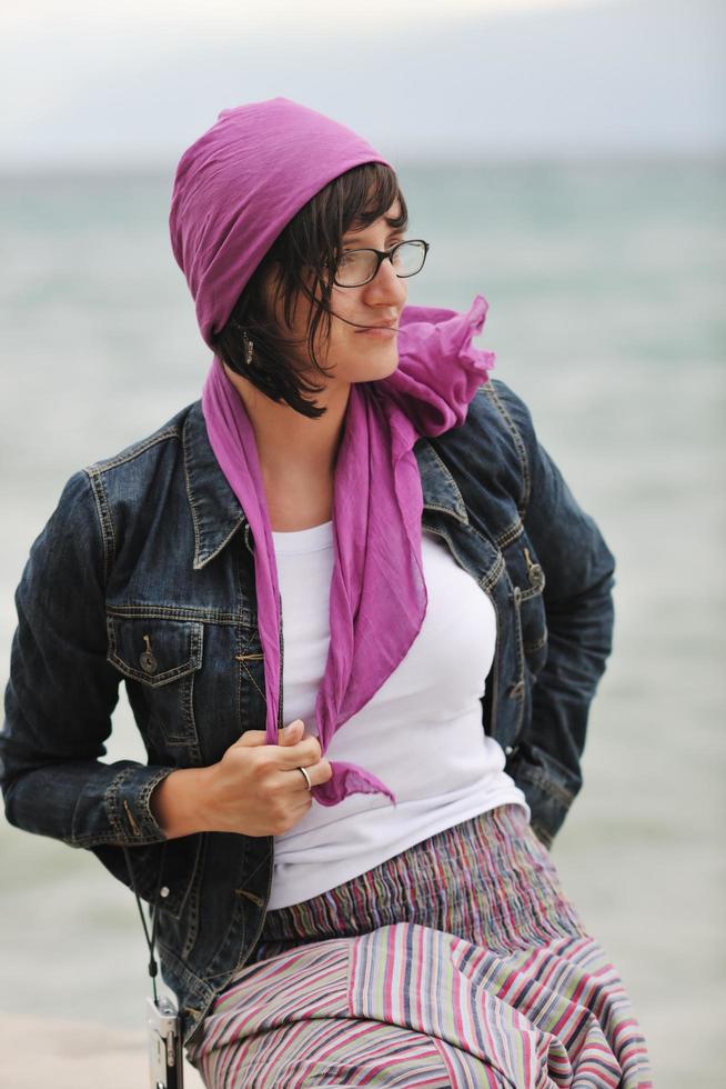 beautiful young woman on beach with scarf photo