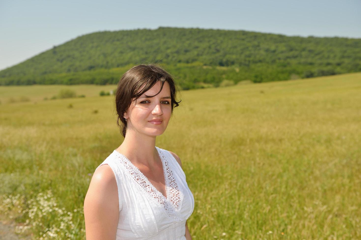 Young happy woman in green field photo