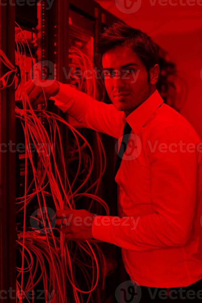 young it engineer in datacenter server room photo