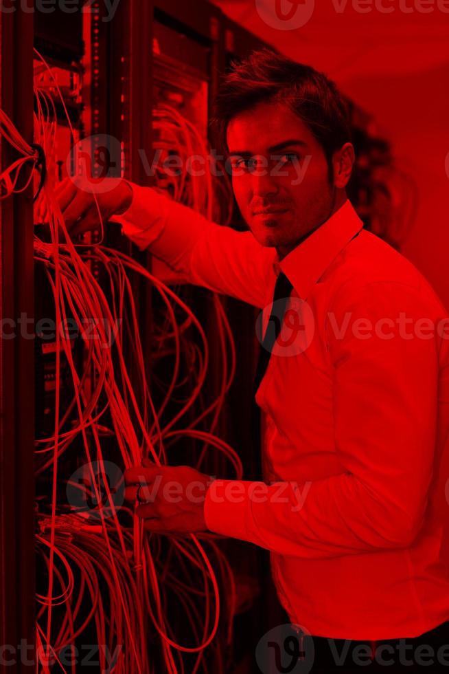 young it engineer in datacenter server room photo