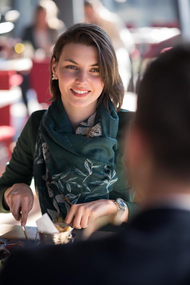 Closeup shot of young woman and man having meal. photo