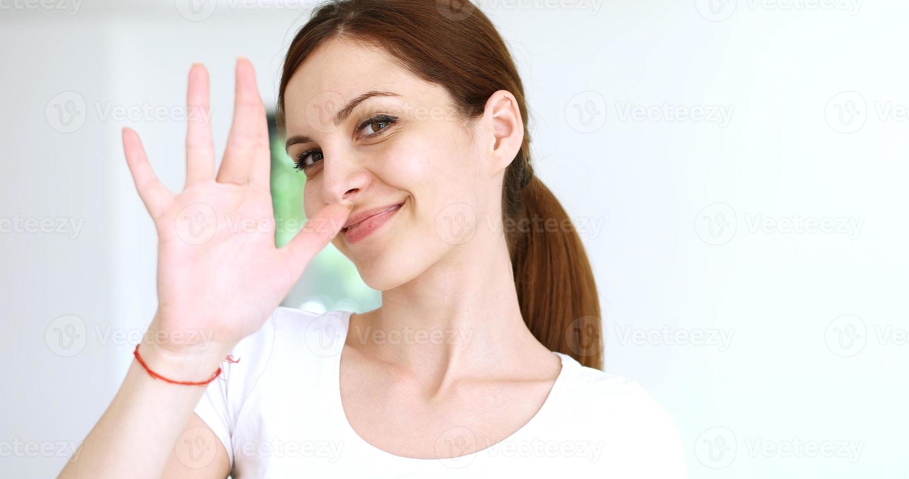 woman sending kiss to camera in modern apartment photo
