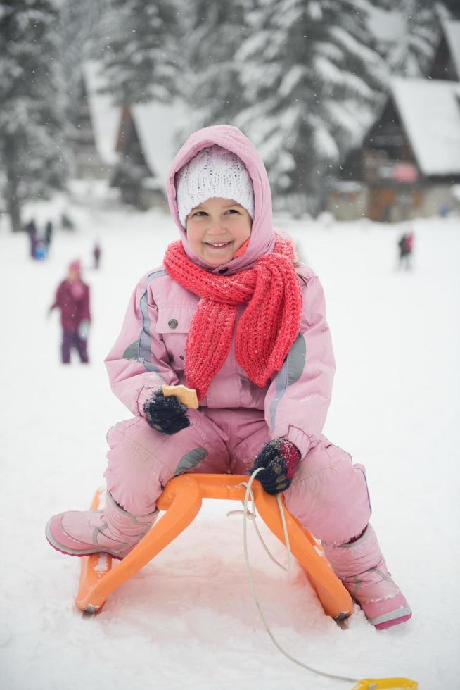 little girl sitting on sledges photo