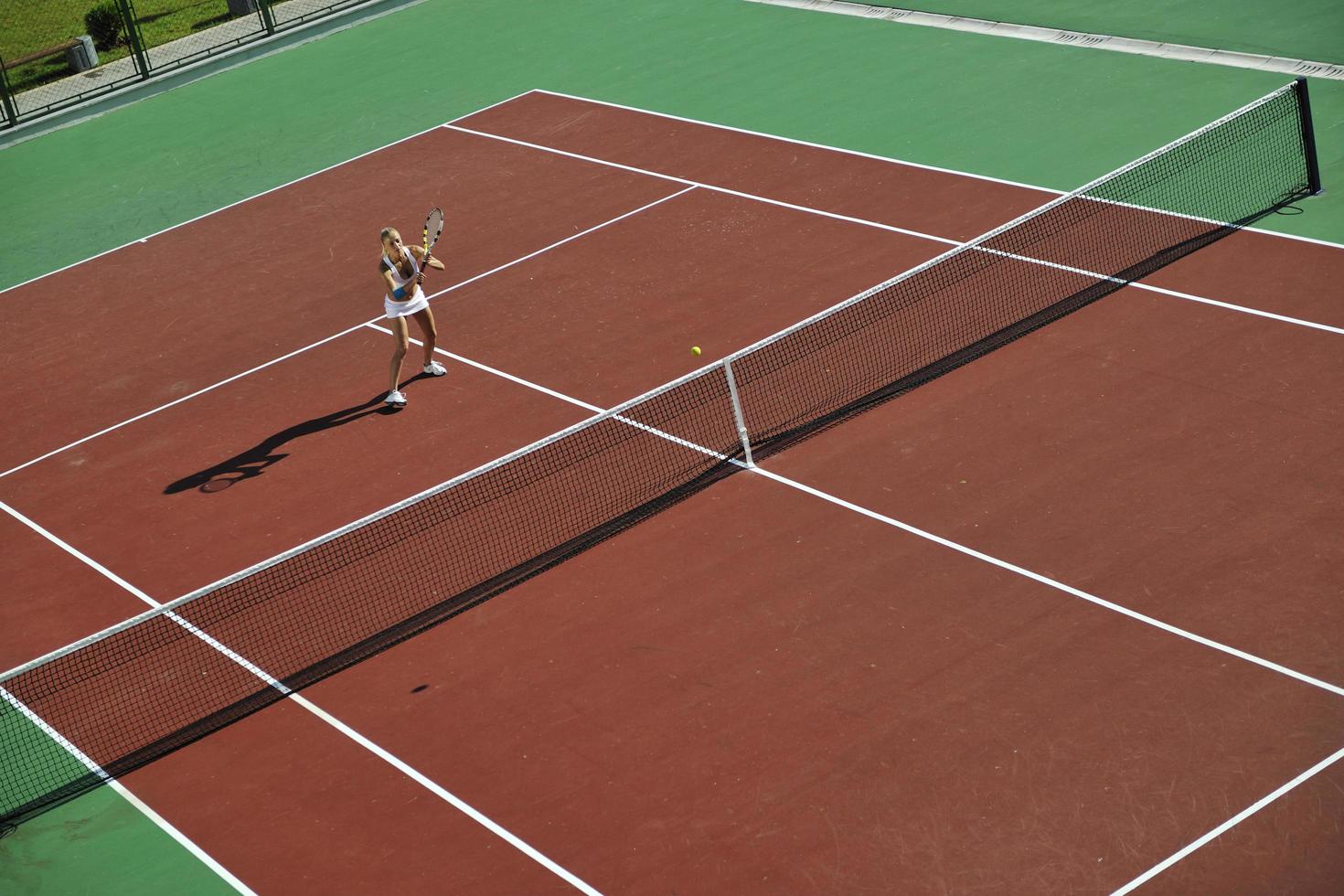 young woman play tennis outdoor photo