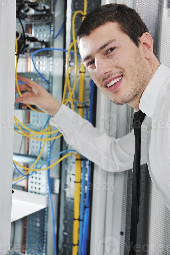 young engeneer in datacenter server room photo
