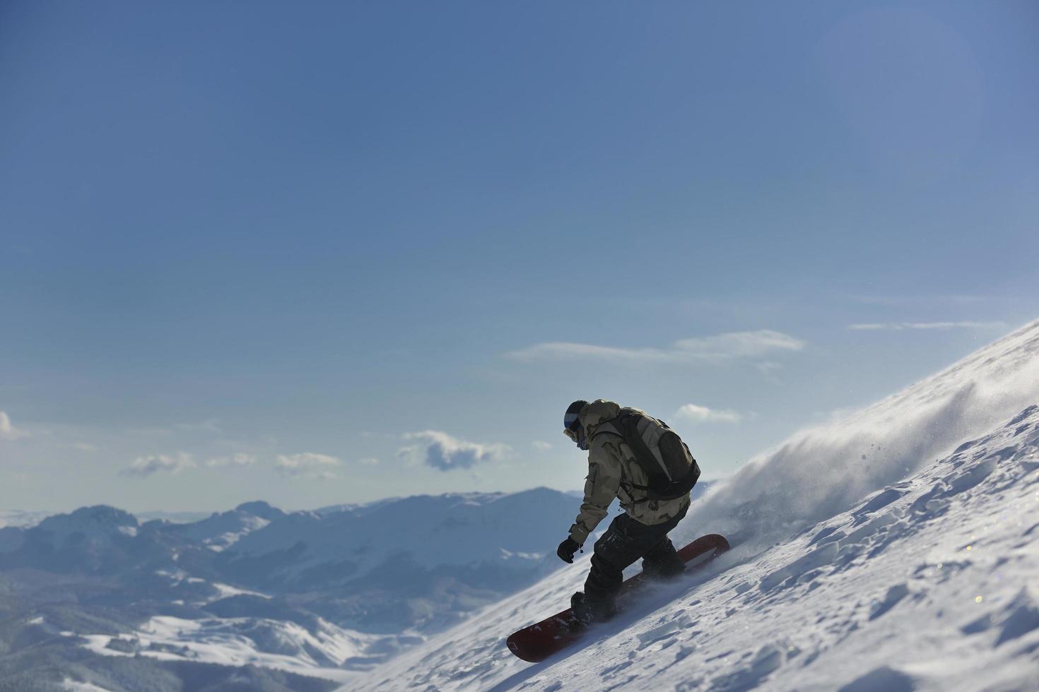 freestyle snowboarder jump and ride photo