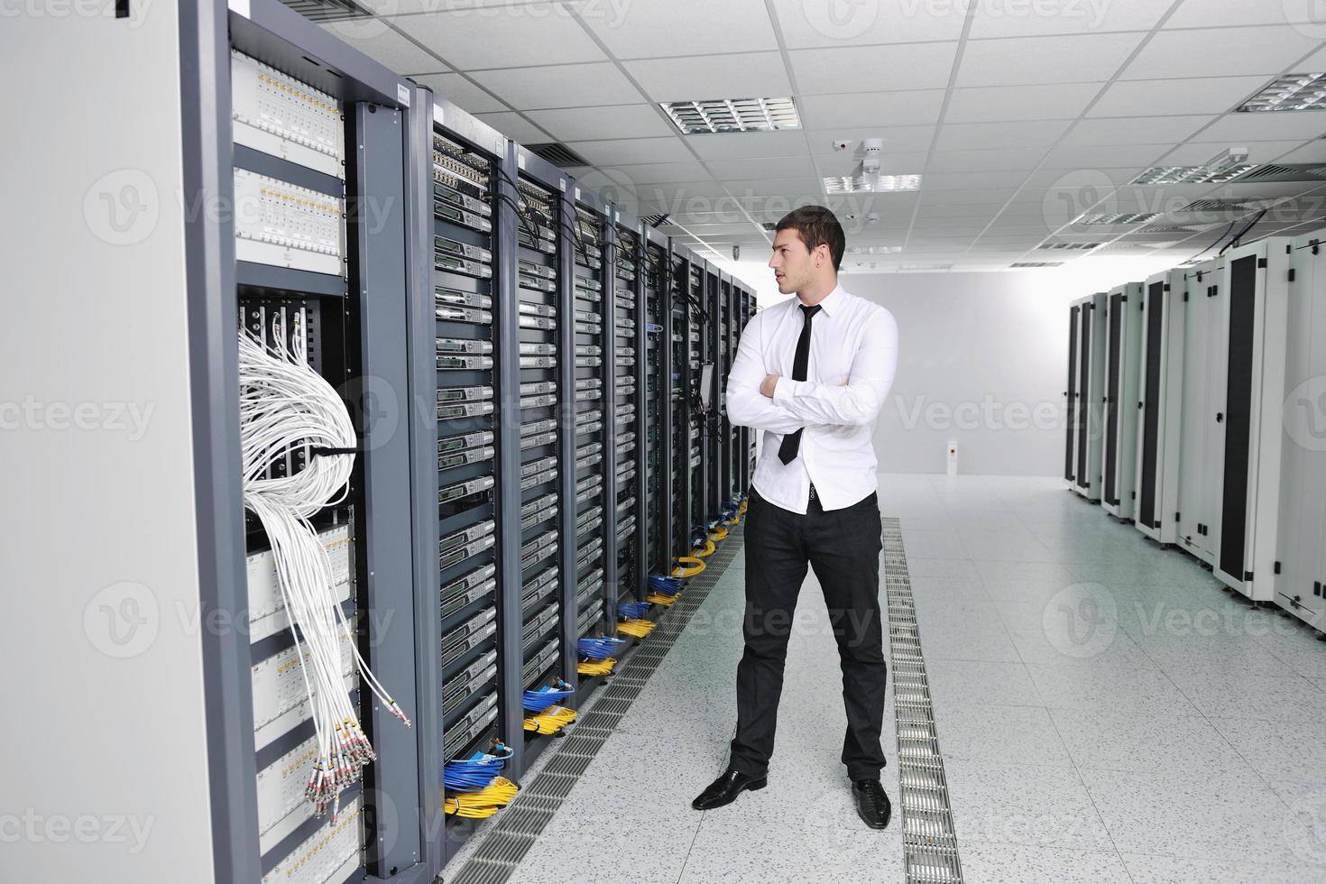 young engeneer in datacenter server room photo