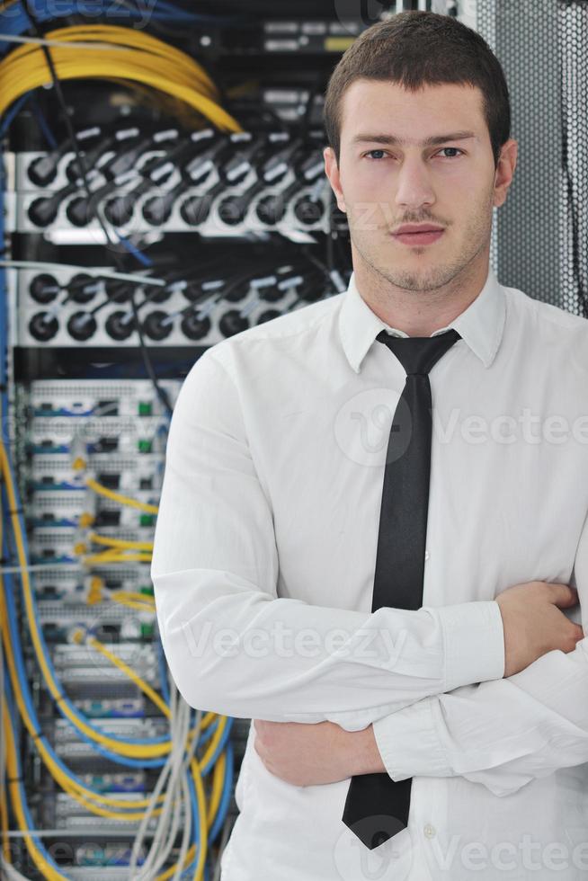 young engeneer in datacenter server room photo