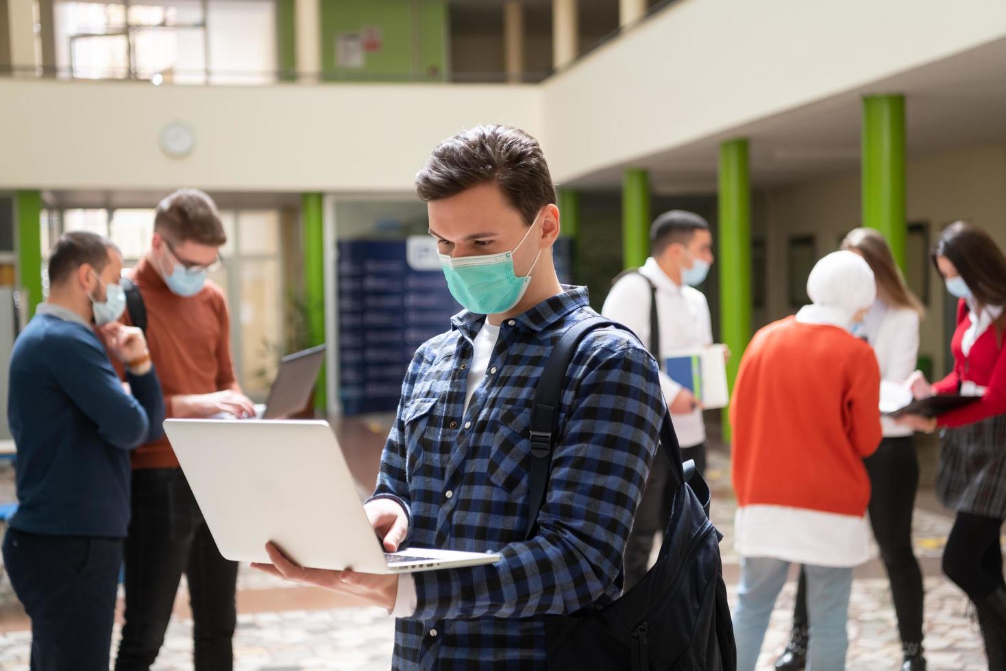 Portrait of multiethnic students group at university wearing protective face mask photo