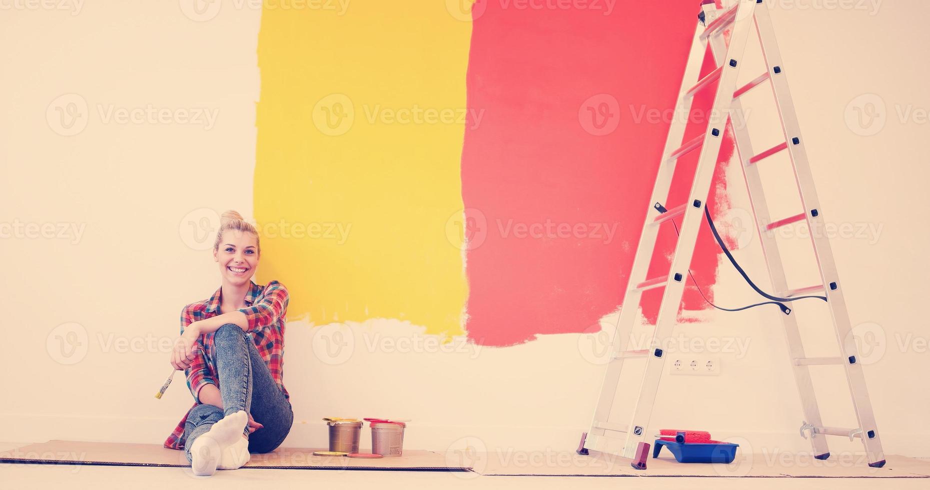 young female painter sitting on floor photo