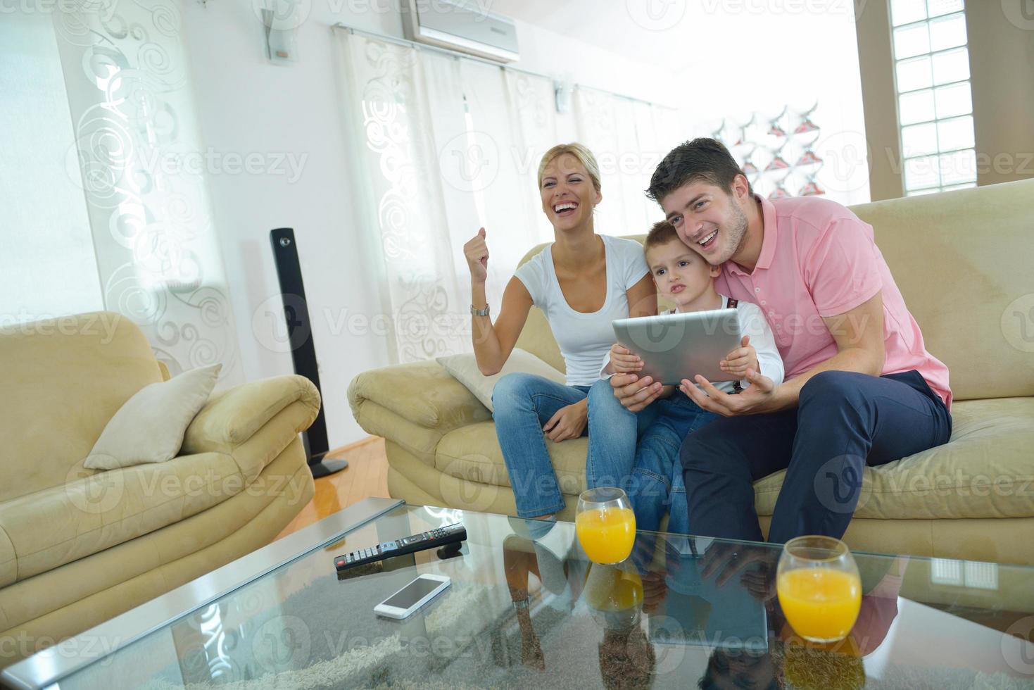 family at home using tablet computer photo