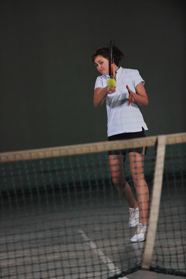 Playing tennis indoors photo