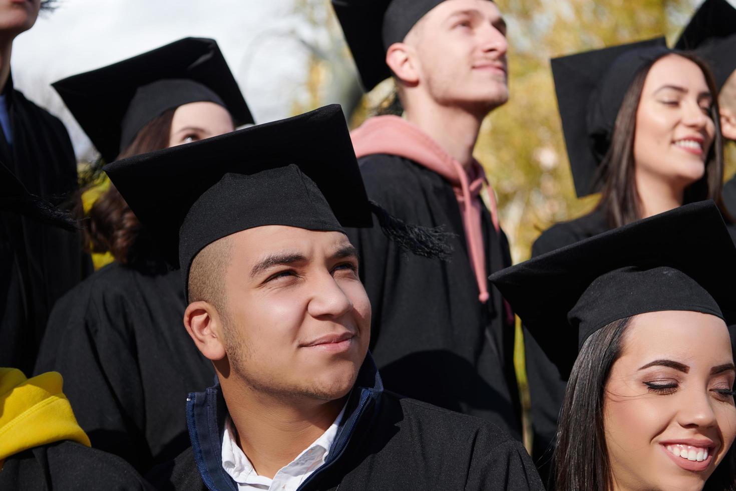 Group of diverse international graduating students celebrating photo