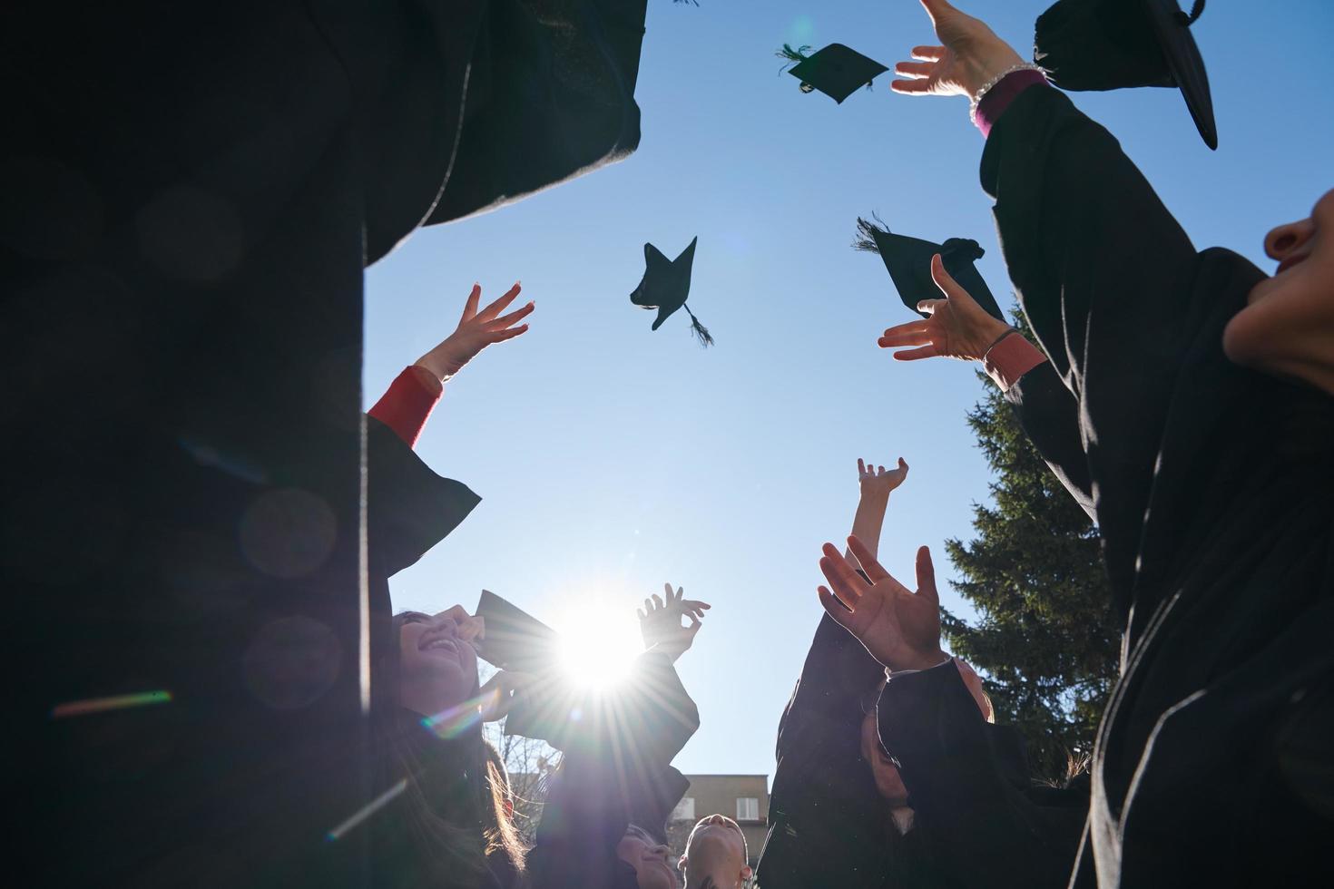 Group of diverse international graduating students celebrating photo