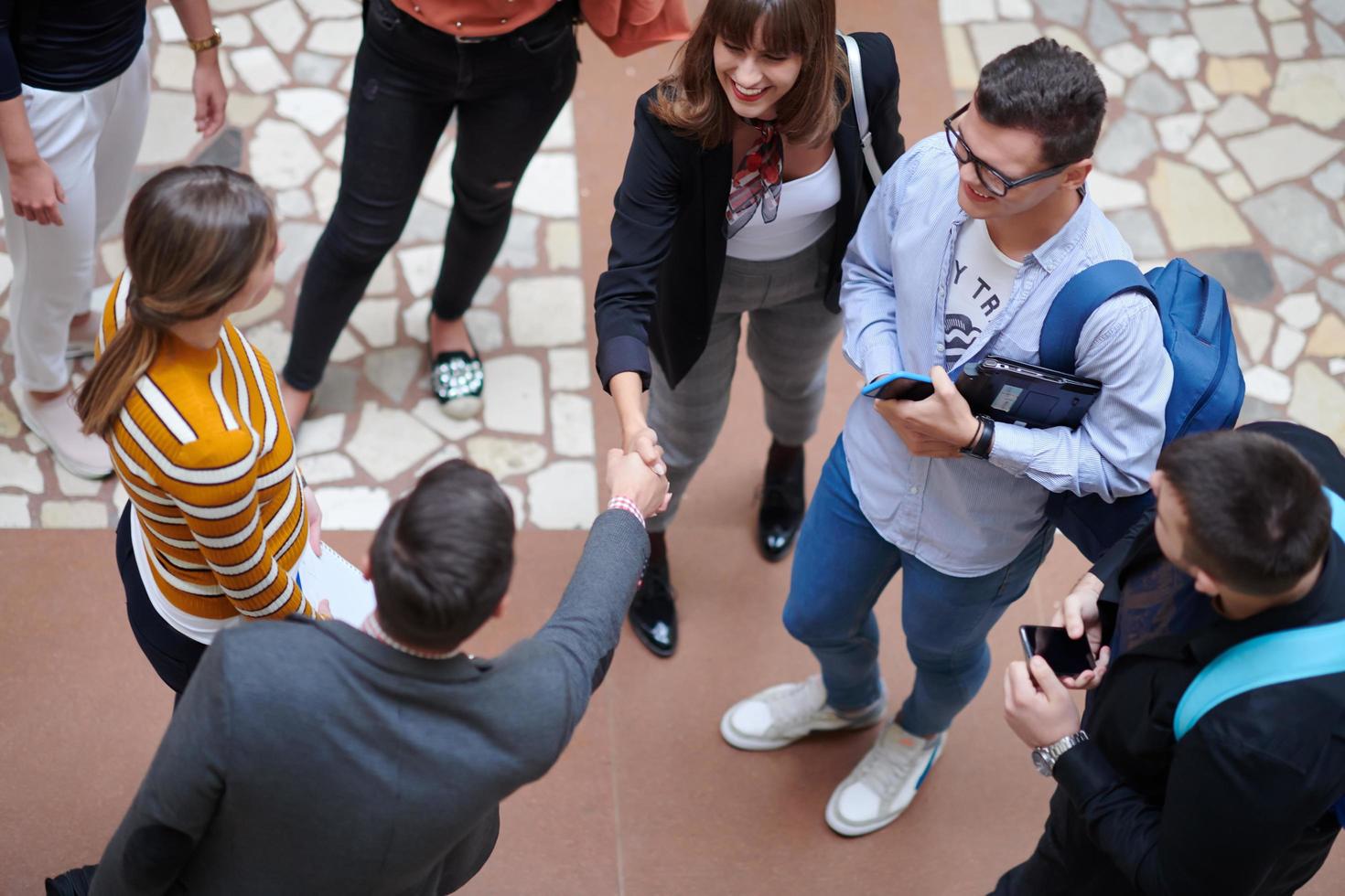 students communication with professor in school corridor photo