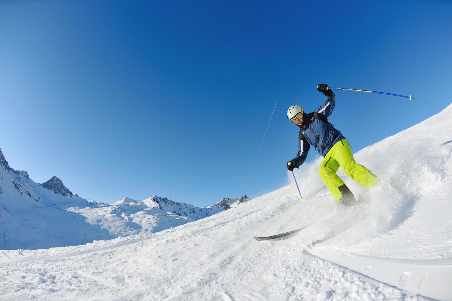 skiing on fresh snow at winter season at beautiful sunny day photo