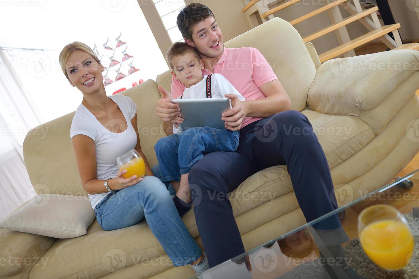 family at home using tablet computer photo