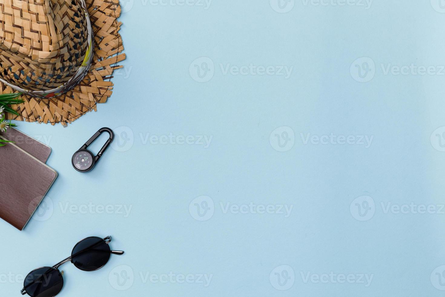 Top view mockup of Traveler's accessories with passport, compass, wallet, camera, hat and airplane toy isolated colorful blue background with empty space, Tropical travel concept photo