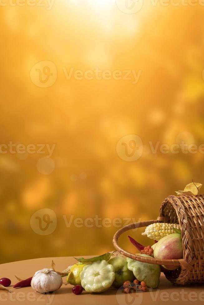 Autumn vertical composition with a basket of apples, squash, peppers on the background of an autumn landscape. Autumn harvest concept photo