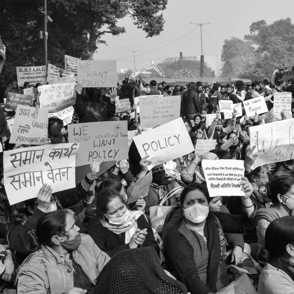Delhi, India December 25 2021 - Delhi Contractual Guest Teachers with posters, flags and graffitis protesting against Delhi AAP Government for making policy, Delhi Teacher protesting Black and White photo