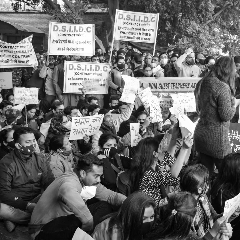 Delhi, India December 25 2021 - Delhi Contractual Guest Teachers with posters, flags and graffitis protesting against Delhi AAP Government for making policy, Delhi Teacher protesting Black and White photo