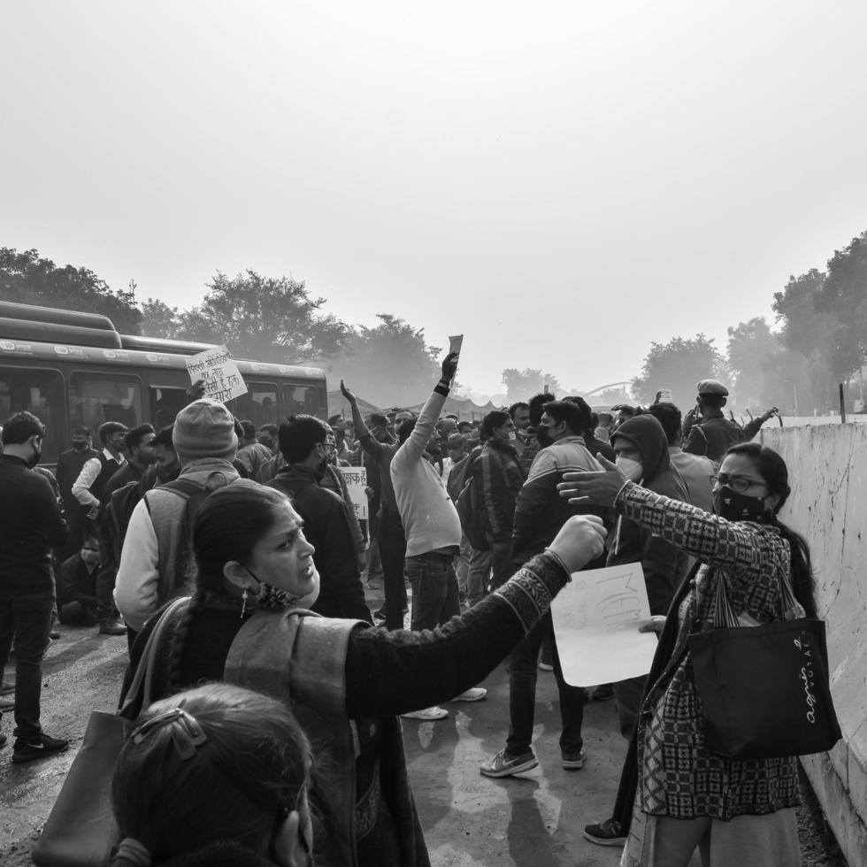 Delhi, India December 25 2021 - Delhi Contractual Guest Teachers with posters, flags and graffitis protesting against Delhi AAP Government for making policy, Delhi Teacher protesting Black and White photo