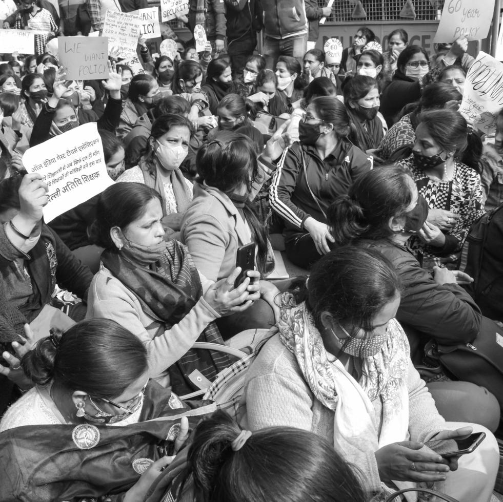 Delhi, India December 25 2021 - Delhi Contractual Guest Teachers with posters, flags and graffitis protesting against Delhi AAP Government for making policy, Delhi Teacher protesting Black and White photo