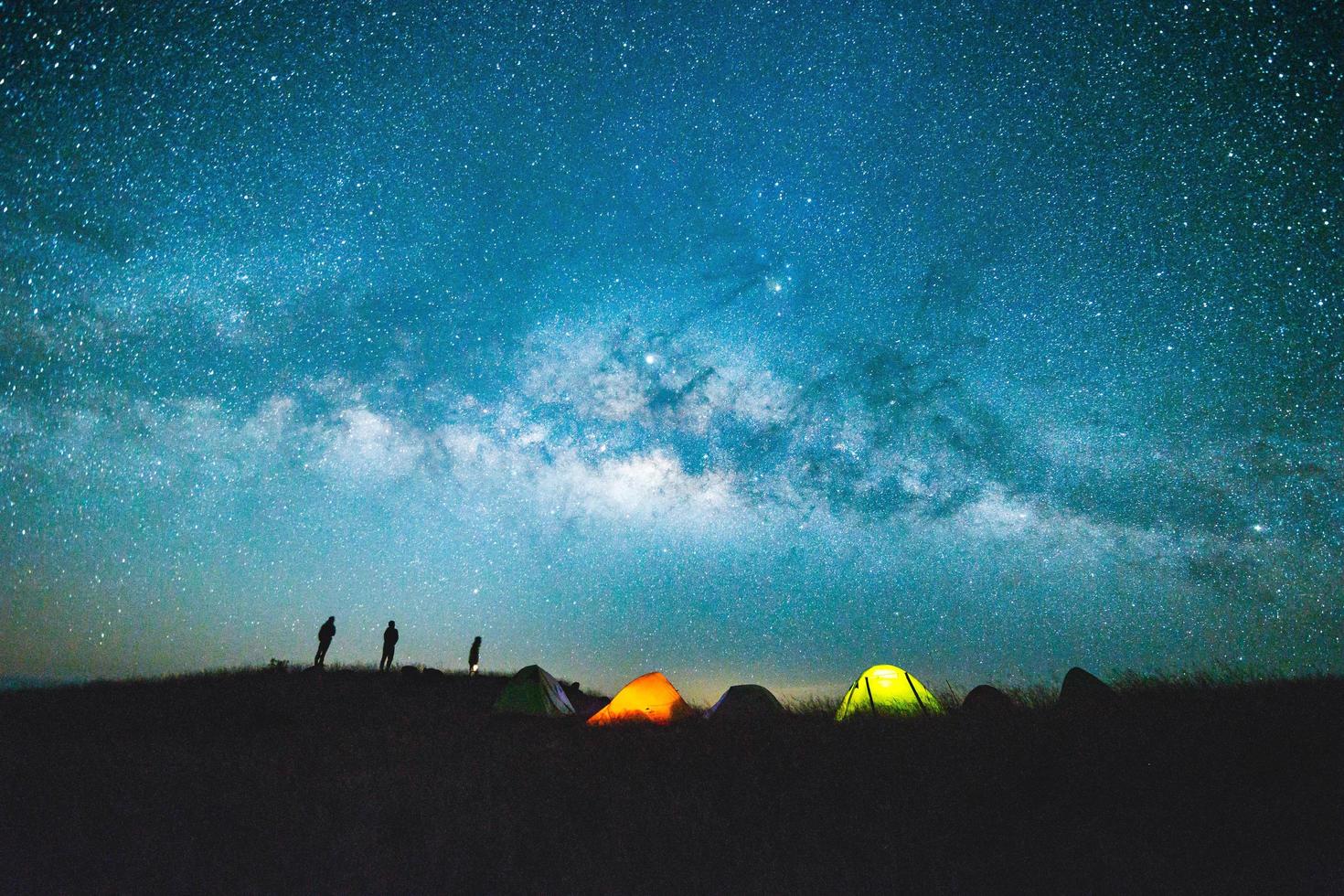 Blue dark  night sky with with star Milky way Space background and silhouette of a standing happy man photo