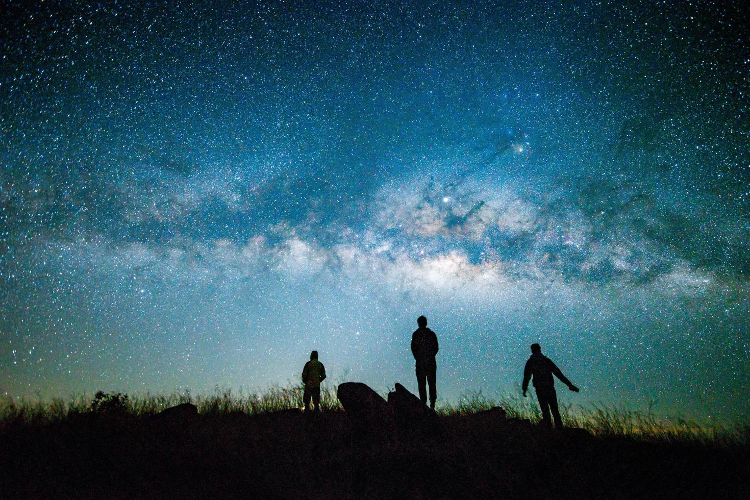 Blue dark  night sky with with star Milky way Space background and silhouette of a standing happy man photo