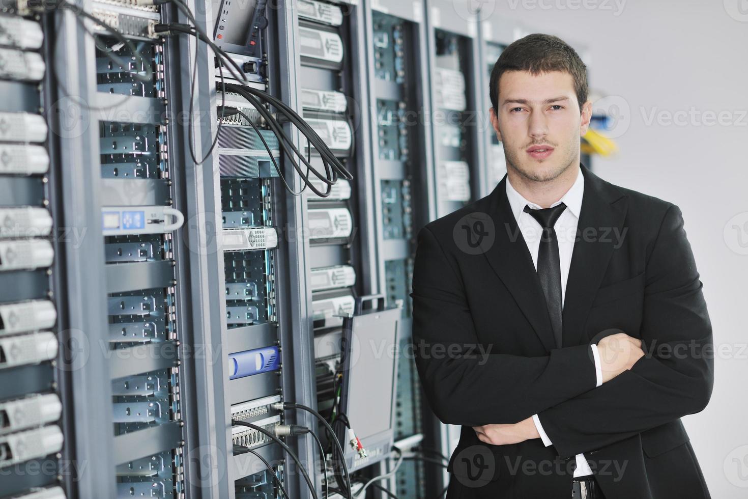 young engeneer in datacenter server room photo