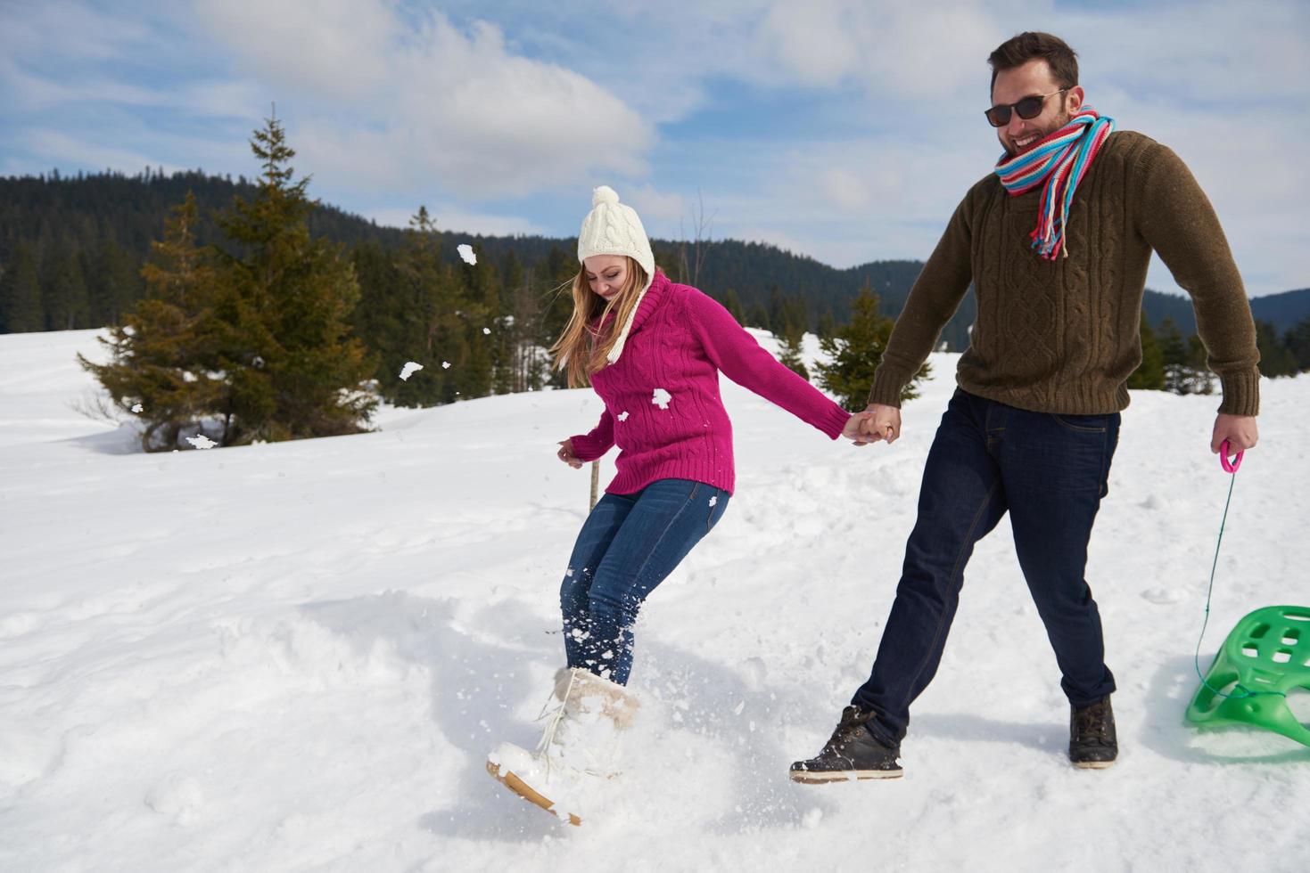 happy young couple having fun on fresh show on winter vacation photo