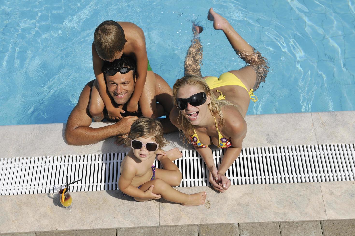 happy young family have fun on swimming pool photo