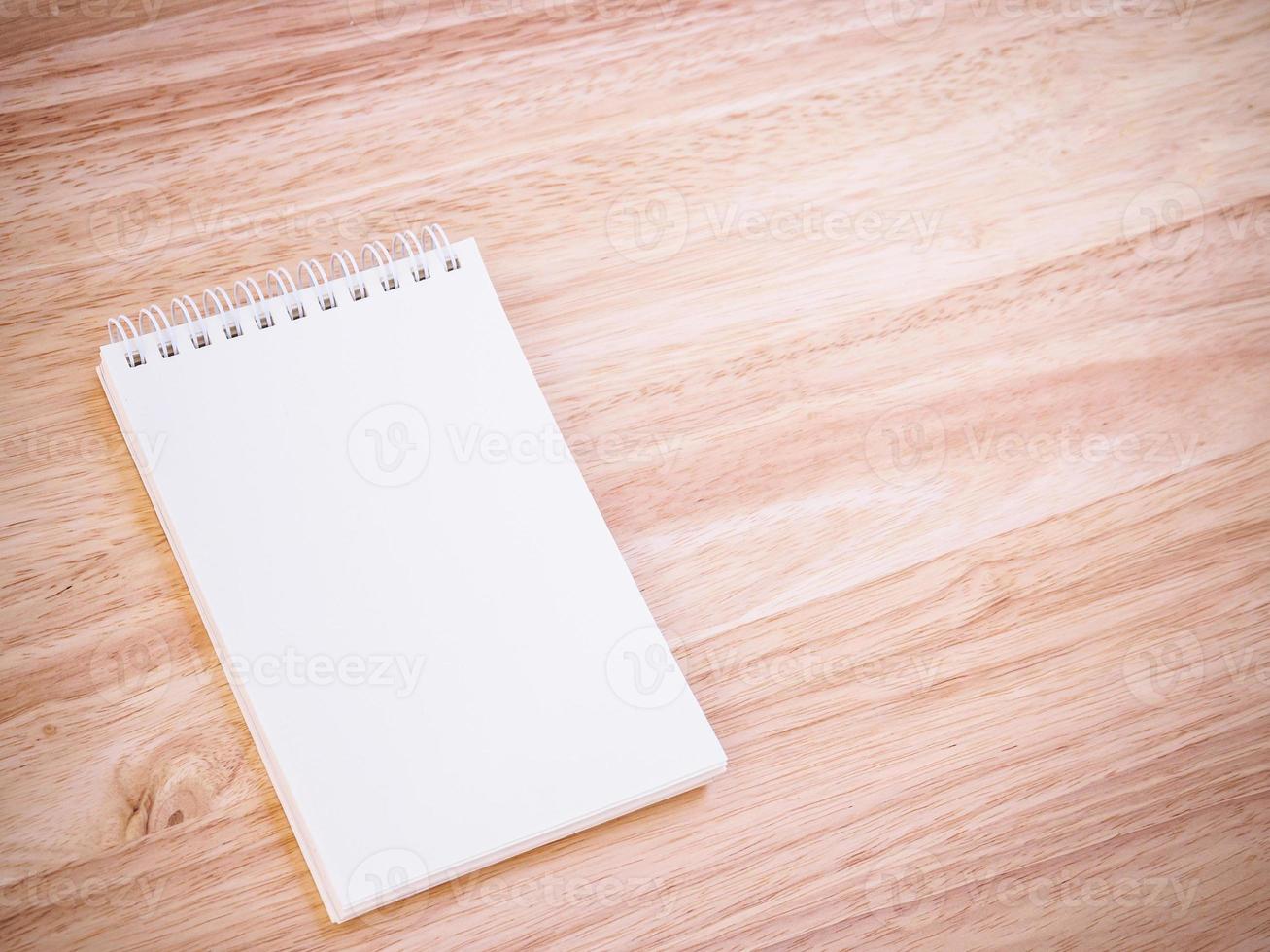 Notepad on the wooden desk table photo